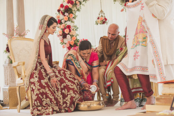 Real bride in gold and red lengha by Dina Kashap