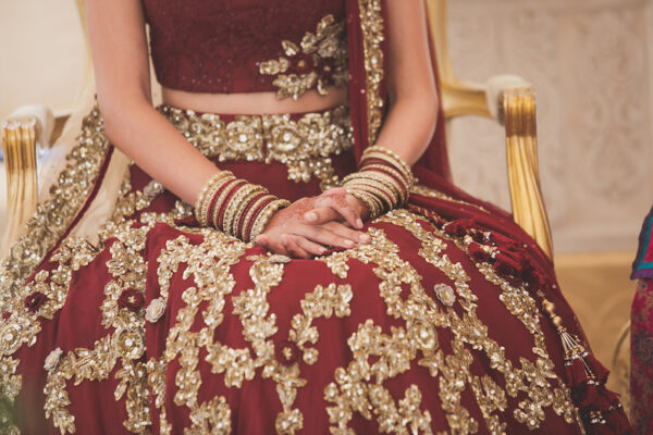 Real bride in gold and red lengha by Dina Kashap