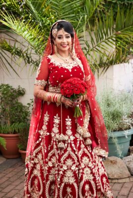 Bride in red and gold lengha - Dina Kashap